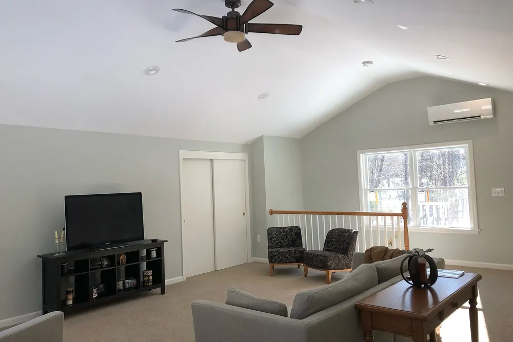 Finished room above the garage with vaulted ceiling and ceiling fan in Groton, MA, by DeFaria Construction