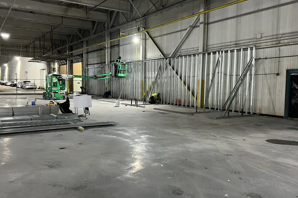Crew framing walls inside a large commercial facility in Framingham MA