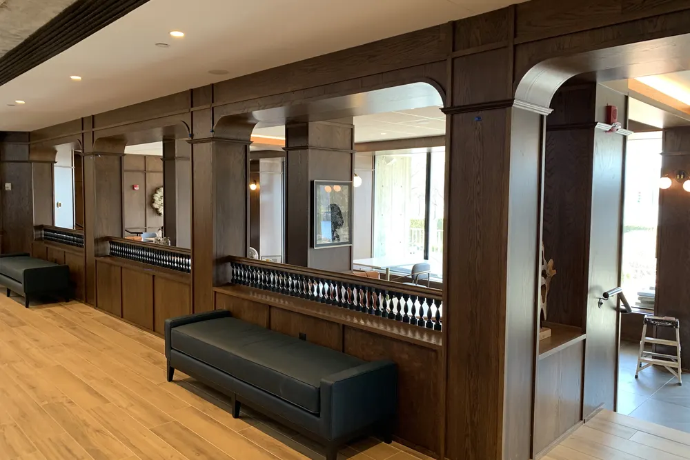 Restaurant interior with custom wood arches, banquette seating and wood floors