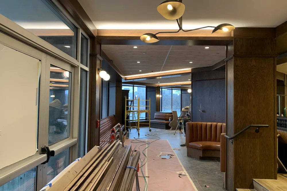 Restaurant interior near completion with wood paneling and new light fixtures