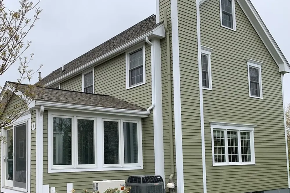 Side elevation with fresh exterior paint and replaced window trims, DeFaria project