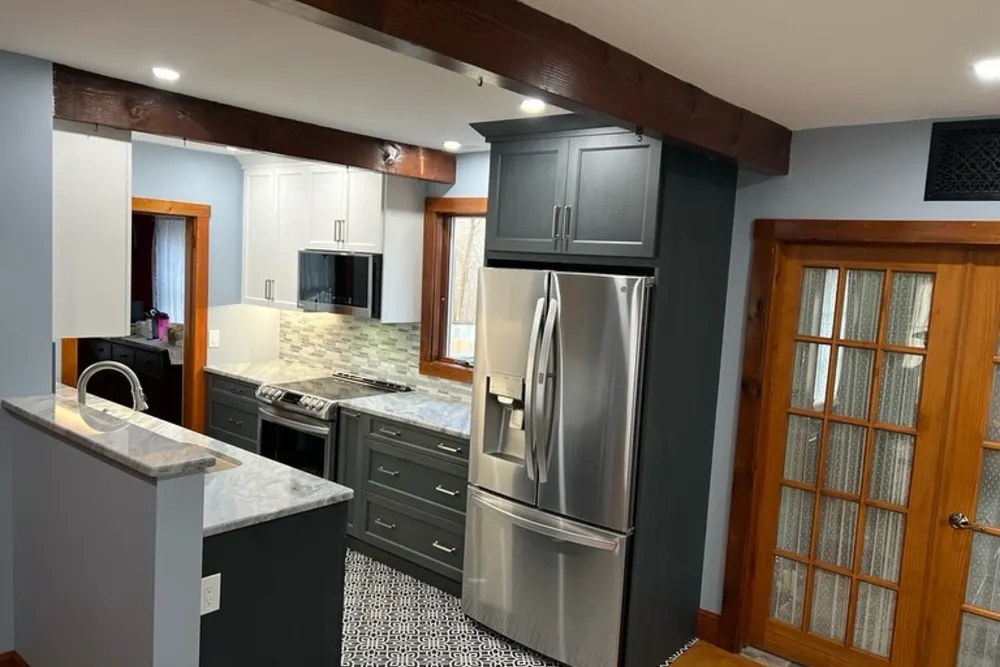Kitchen remodel with gray cabinets, stainless appliances and patterned tile floor in Dracut, MA, by DeFaria Construction